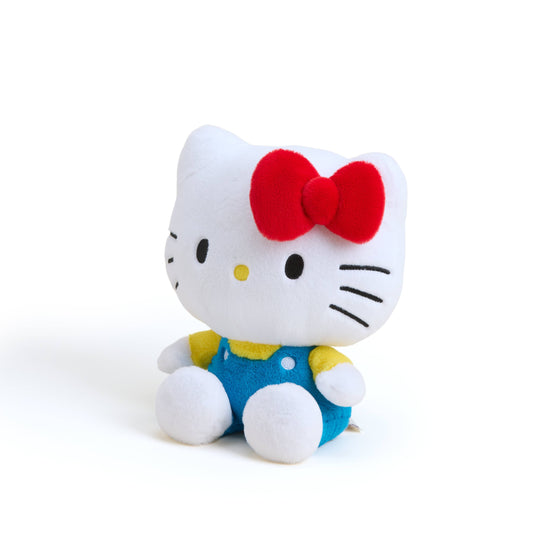 Hello kitty plush toy with a red bow on a white background