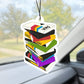 Car air freshener shaped like a stack of colorful VHS tapes hanging from a car's rearview mirror.
