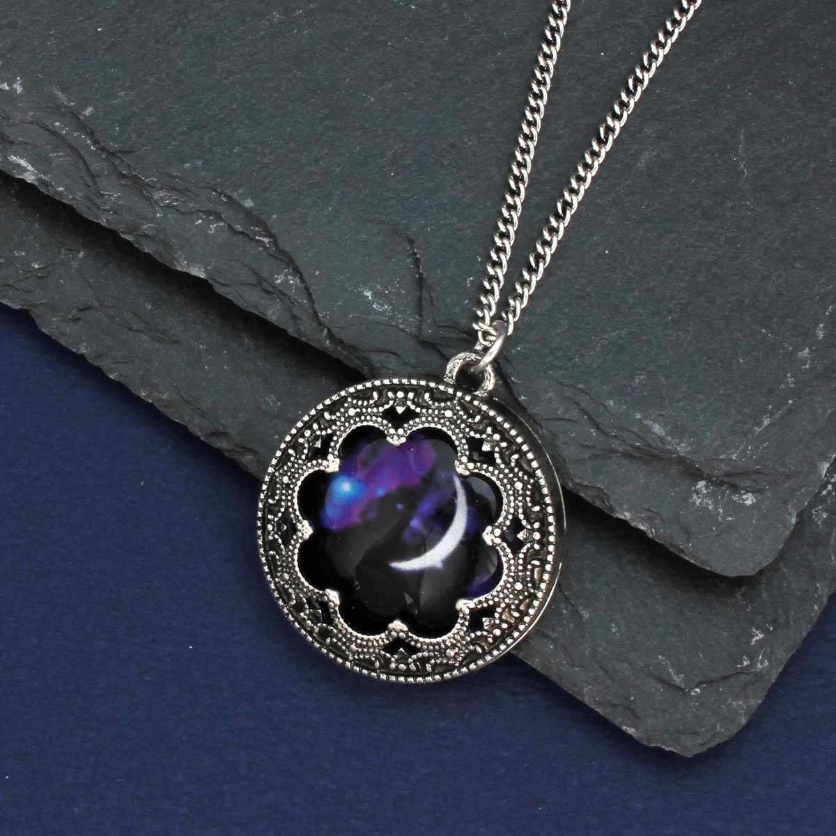 Necklace with a decorative pendant on a dark surface