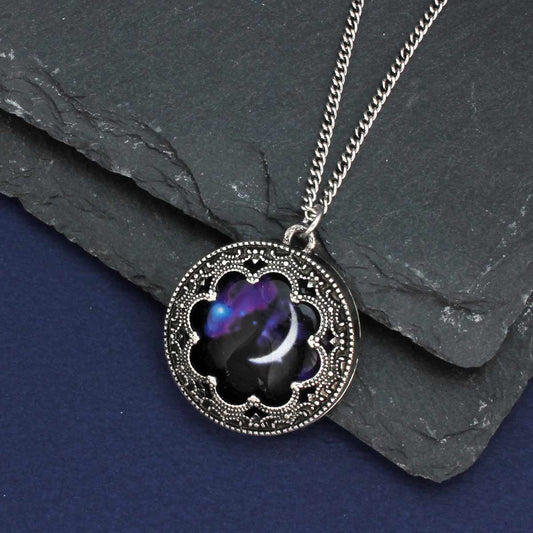 Necklace with a decorative pendant on a dark surface