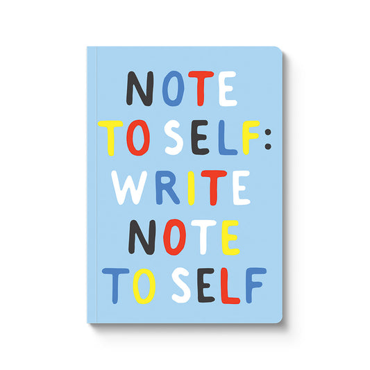 Notebook with colorful text 'NOTE TO SELF: WRITE NOTE TO SELF" on a light blue background