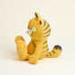Yellow cat Garfield plush toy with black stripes on a beige background