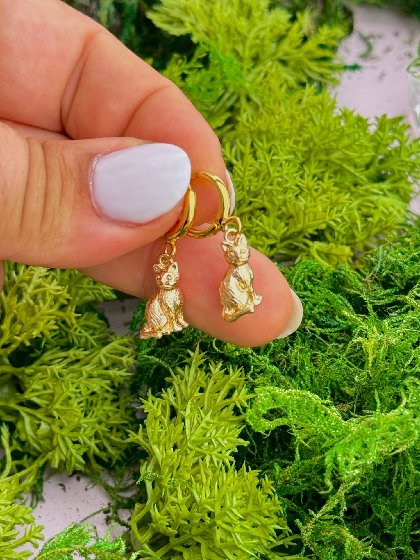 Gold hoop earrings with detailed cats