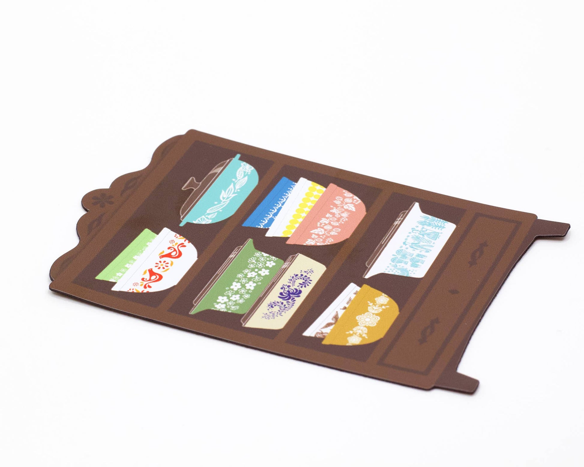 Magnet of a shelf with colorful bowls designs on a white background