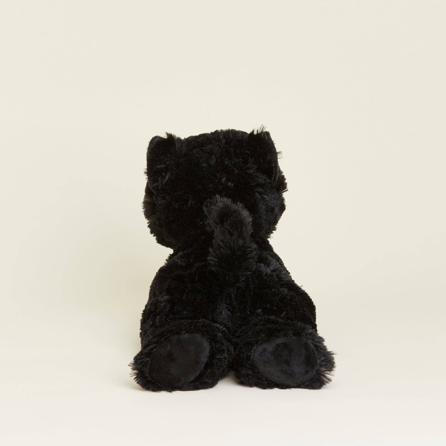 Black cat stuffed animal on a white background