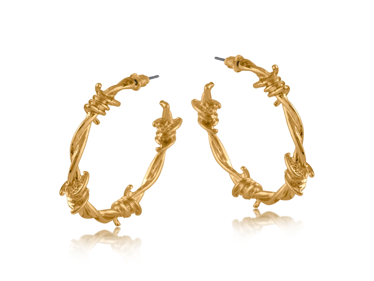 Gold hoop earrings with intricate barbed wire designs on a white background