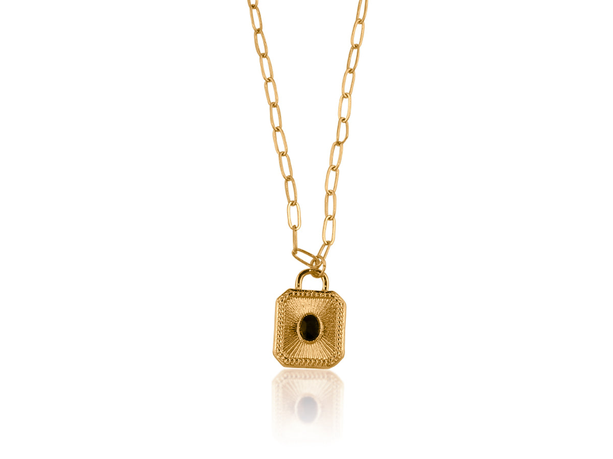 Gold pendant necklace with a black stone on a white background