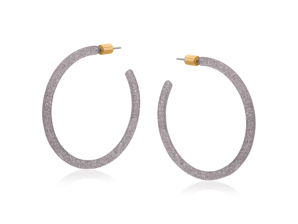 Pair of hoop earrings with glittery texture on a white background