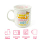White mug with colorful text "What would Dolly do?" and graphics on a white background