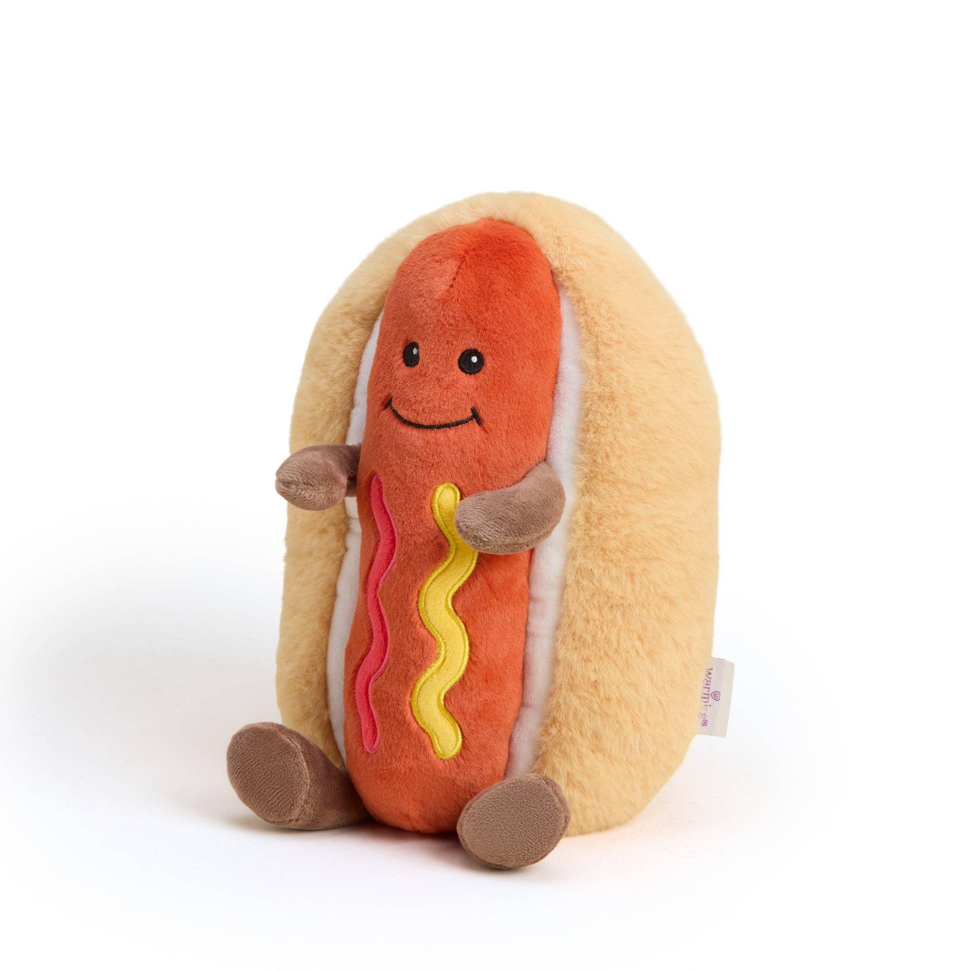 Plush toy hot dog with bun on a white background