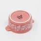 Pink ceramic bowl with floral patterns and 'Twinkl toast' text on a white background