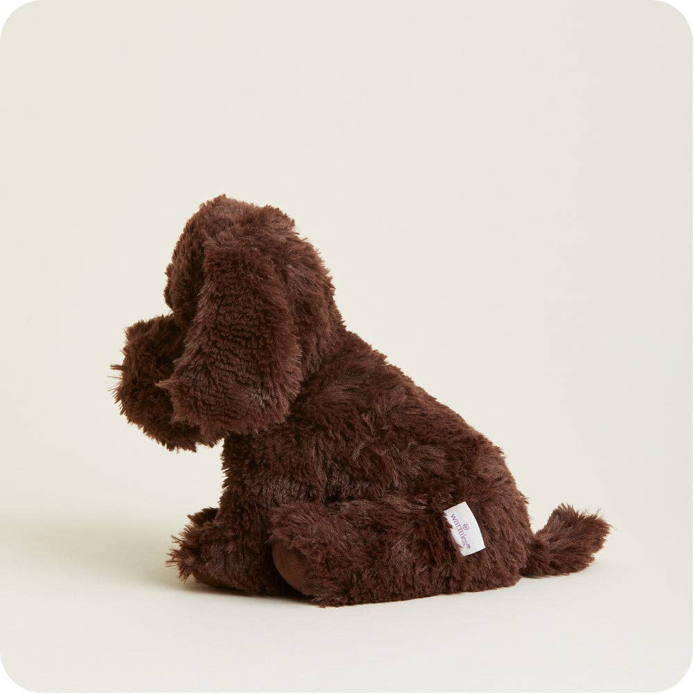 Brown plush dog toy on a light beige background