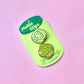 Pickle-shaped hair clips on a green card with 'Peach Heart' branding against a pink background