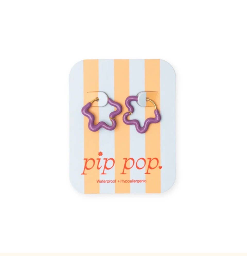 Flower-shaped earrings on a 'pip pop' branded card with orange and white stripes.