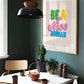Modern interior with a dining table, chairs, and a motivational poster on the wall.