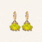 Frog-shaped earrings with gold hooks on a light background