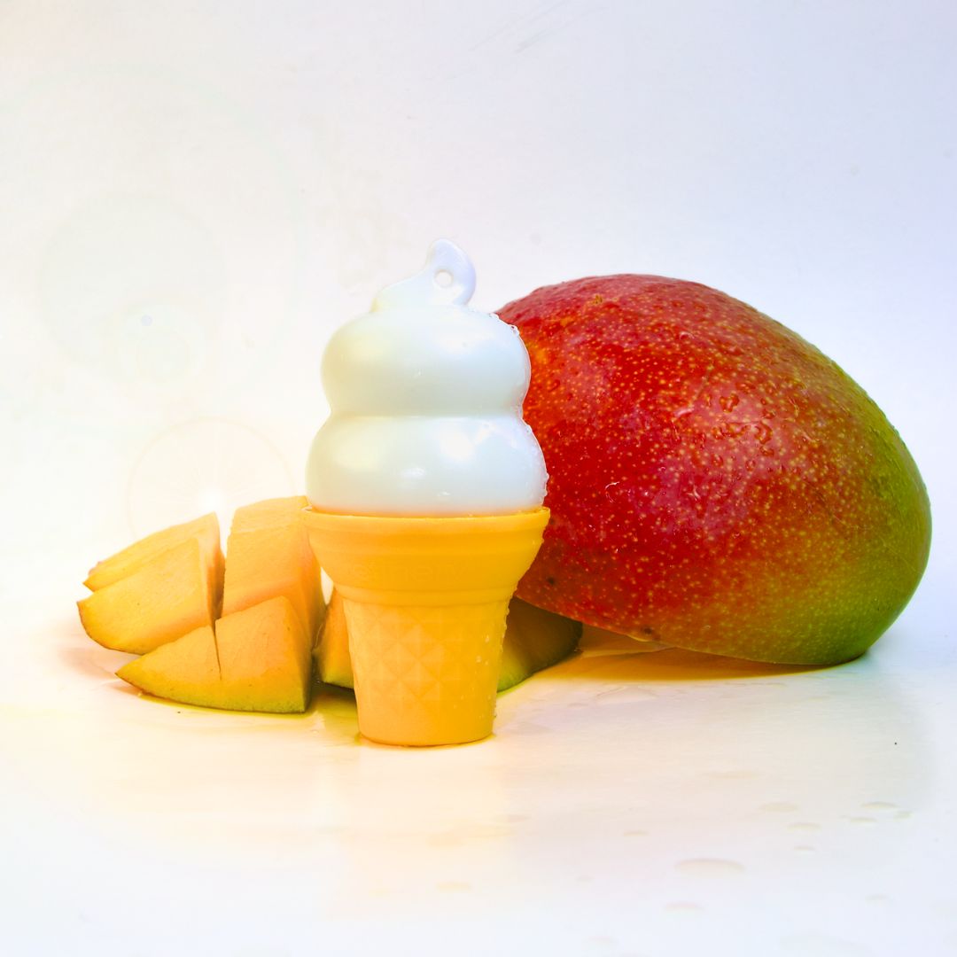 Ice cream cone-shaped hand lotion with mango pieces on a white background