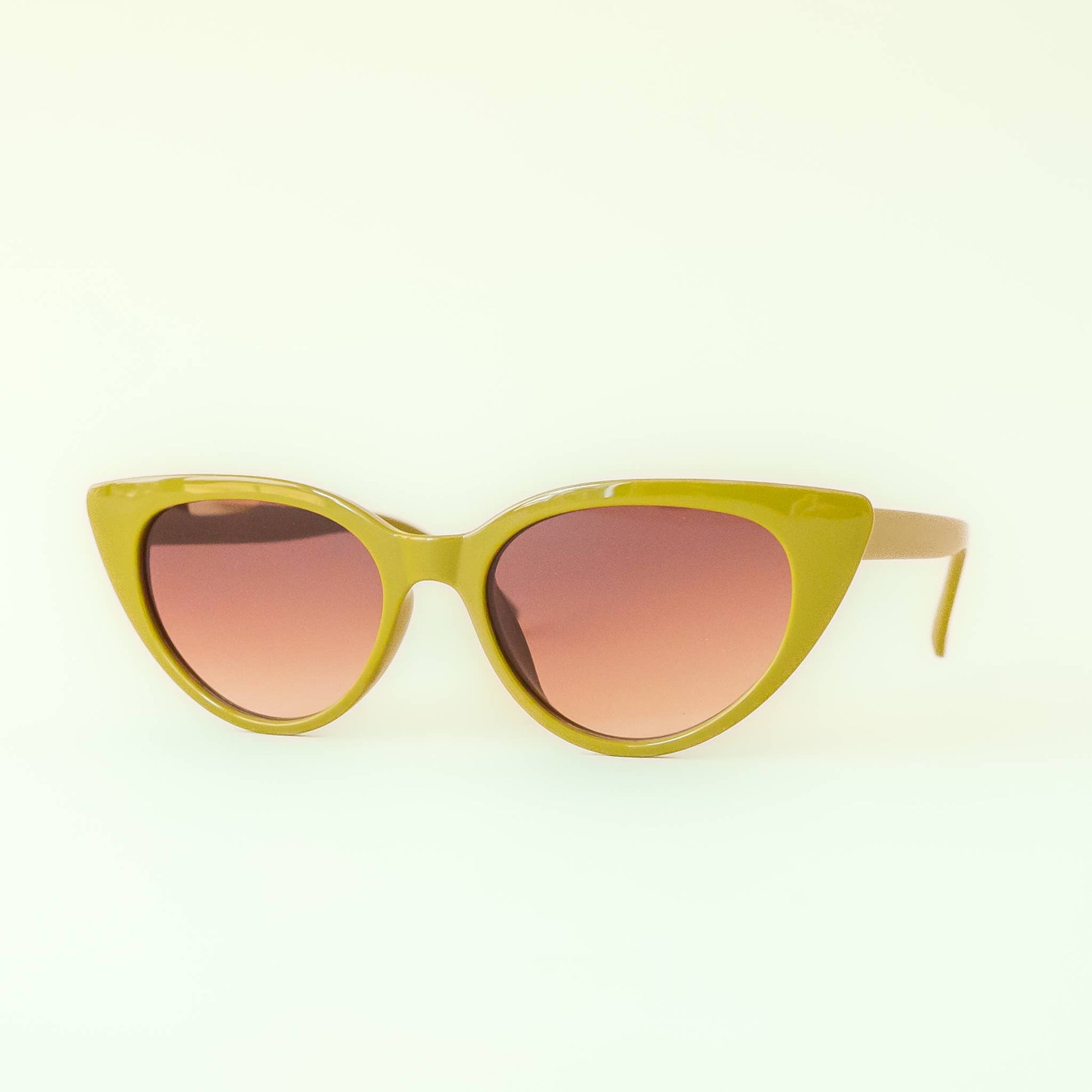 Cat-eye sunglasses with yellow frame and pink gradient lenses on a white background