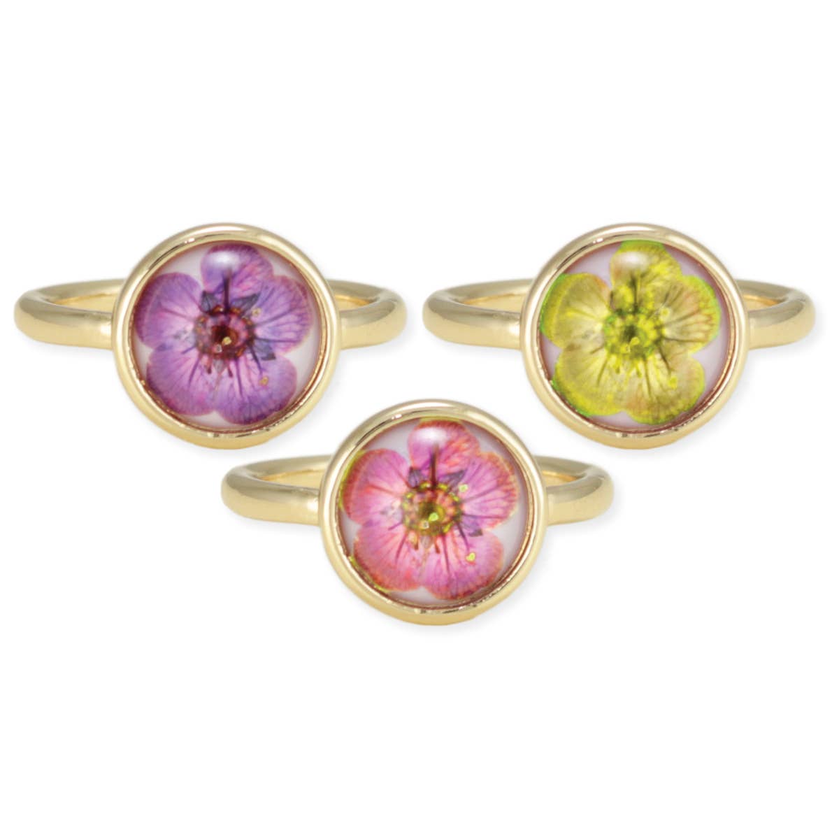 Three floral-themed rings with gold bands on a white background