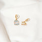 mismatched gold huggie earrings of oat milk and coffee on a white background