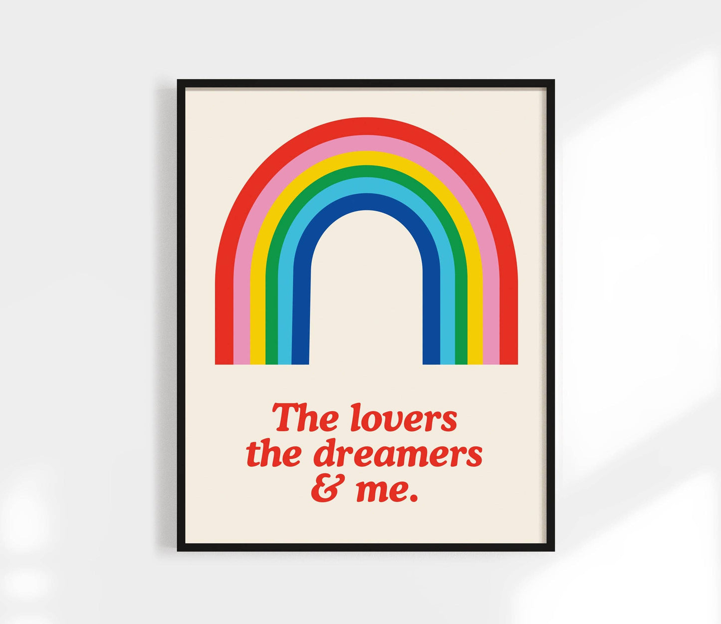 Framed poster with a rainbow and text on a white background