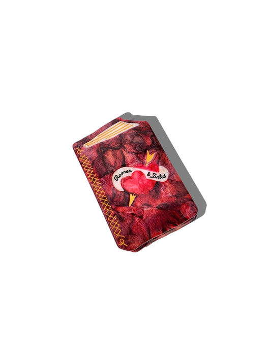 Small book claw clip that says "Romeo and Juliet" on a white background