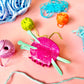 Colorful yarn and knitting tools hair claw clip on a pink background