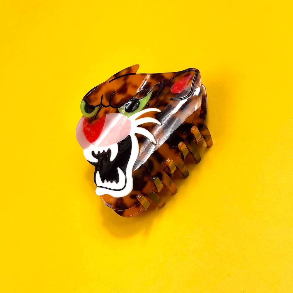 Tortoiseshell tiger head hair clip on a yellow background