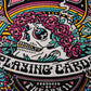 Colorful graphic design with a skull, flowers, and text on a black background