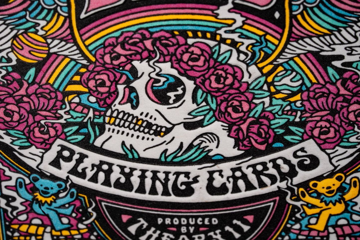 Colorful graphic design with a skull, flowers, and text on a black background