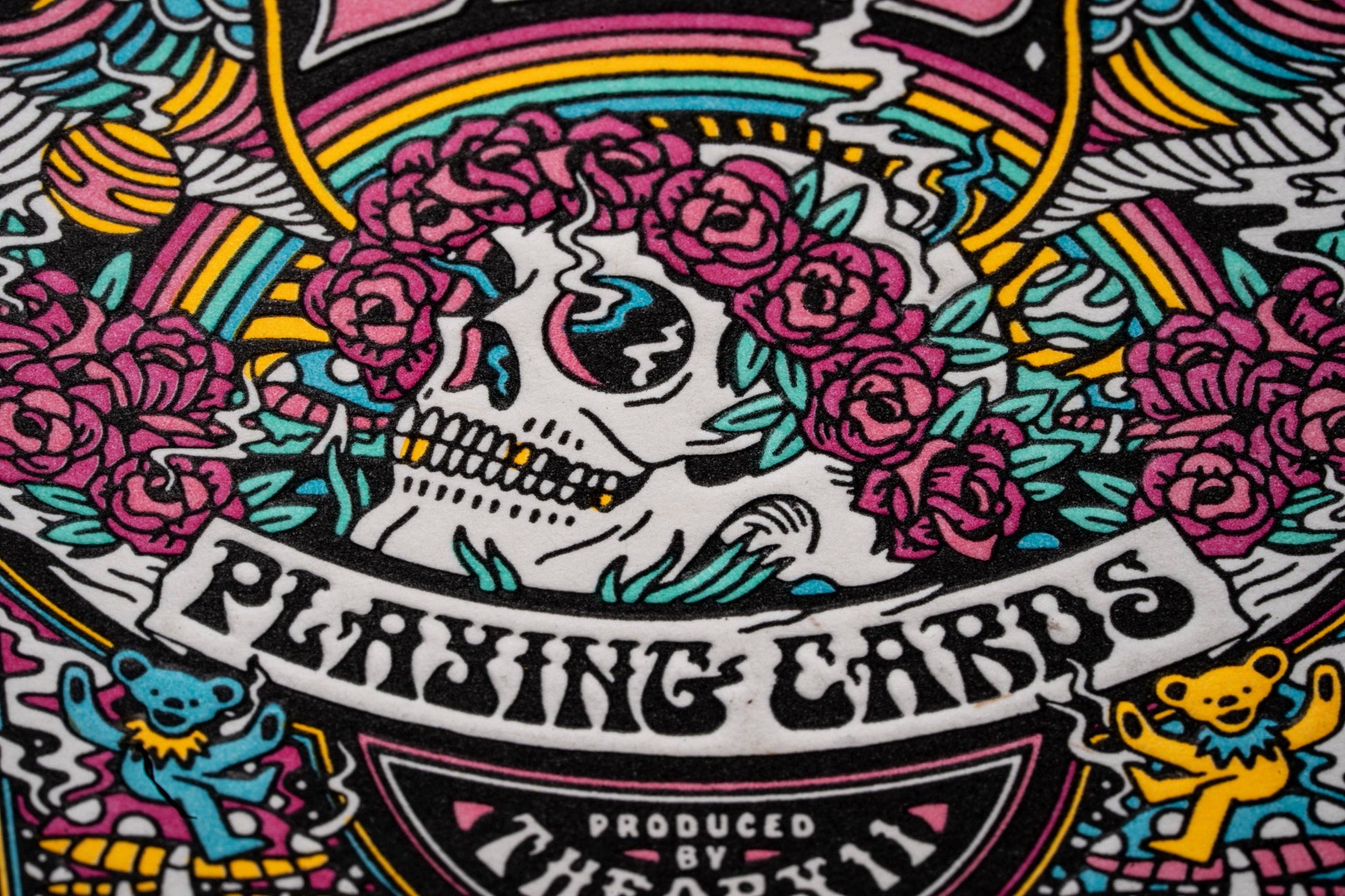 Colorful graphic design with a skull, flowers, and text on a black background