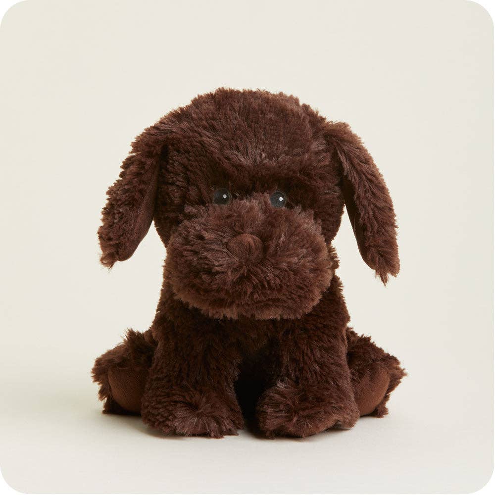 Brown plush dog toy on a light beige background