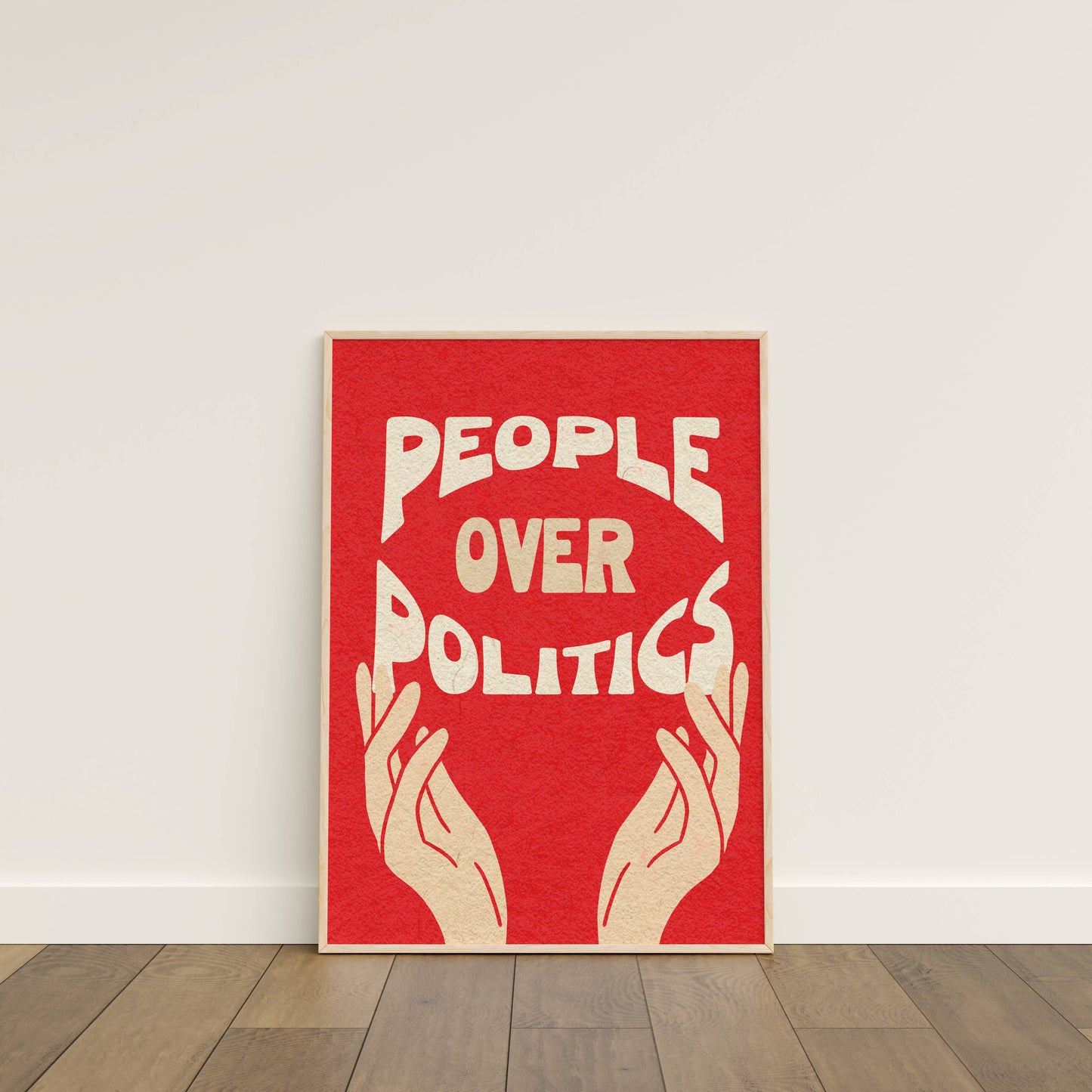 Red poster with 'People Over Politics' text and hands on a white wall.