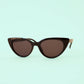 Cat-eye sunglasses with brown lenses on a light green background