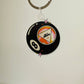 Keychain with 'Ask a Therapist' design on a plain background