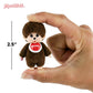 Small Monchhichi figurine held between fingers with a measurement label indicating 2.5 inches.