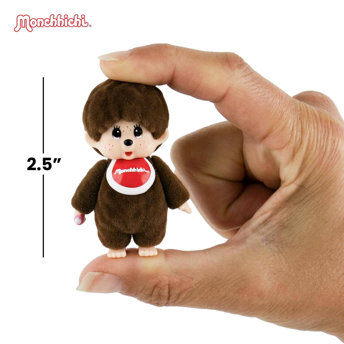Small Monchhichi figurine held between fingers with a measurement label indicating 2.5 inches.