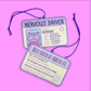 Cartoon driver's license car air freshener with 'Nervous Driver' text on a pink background