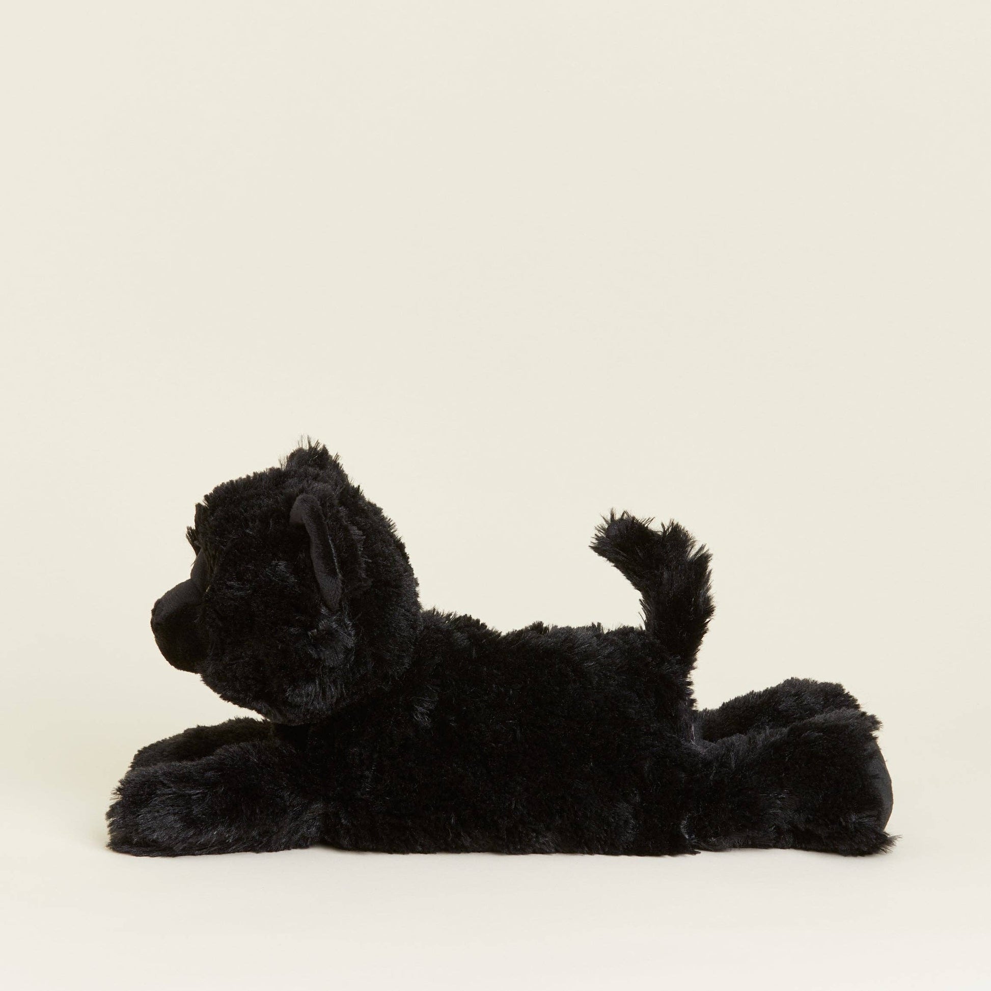 Black plush toy lying on a white background