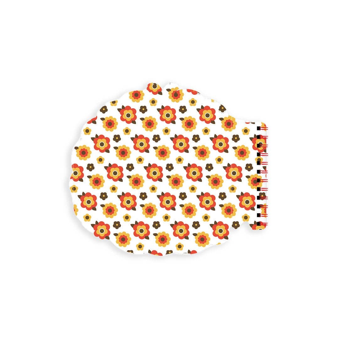 Round white notebook with orange and yellow floral pattern on a white background