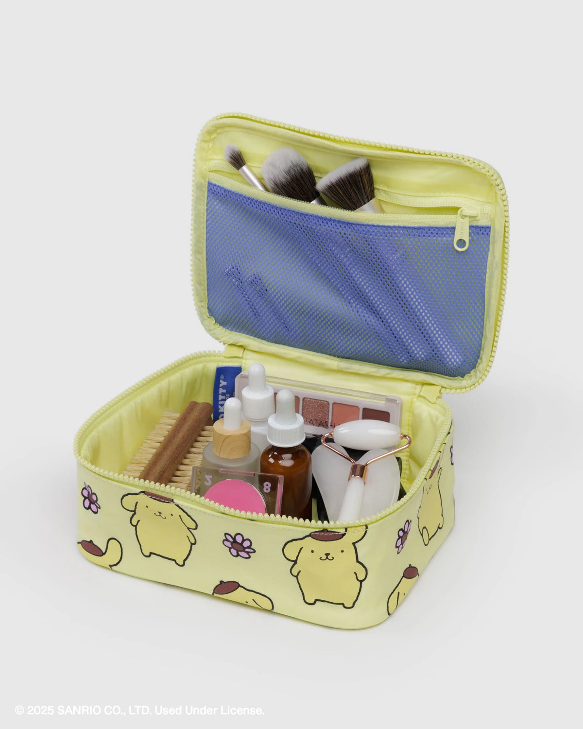 Yellow makeup bag with cartoon design open on a white background
