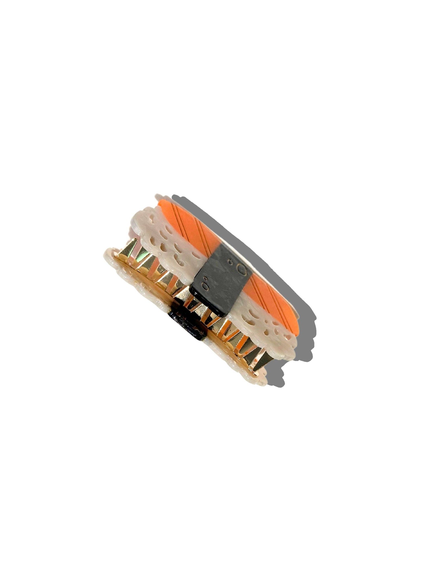 Close-up of a sushi hair clawt with orange and black details on a white background