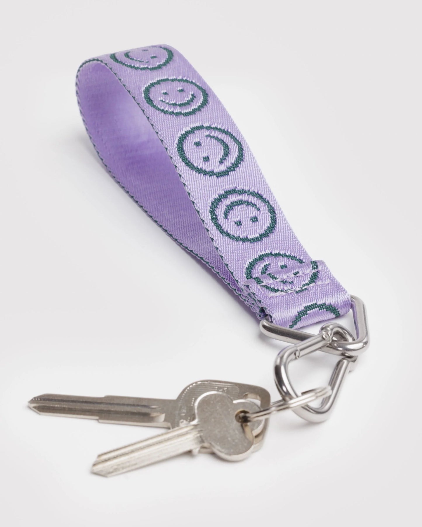 Keychain with purple ribbon featuring smiley face patterns on a white background