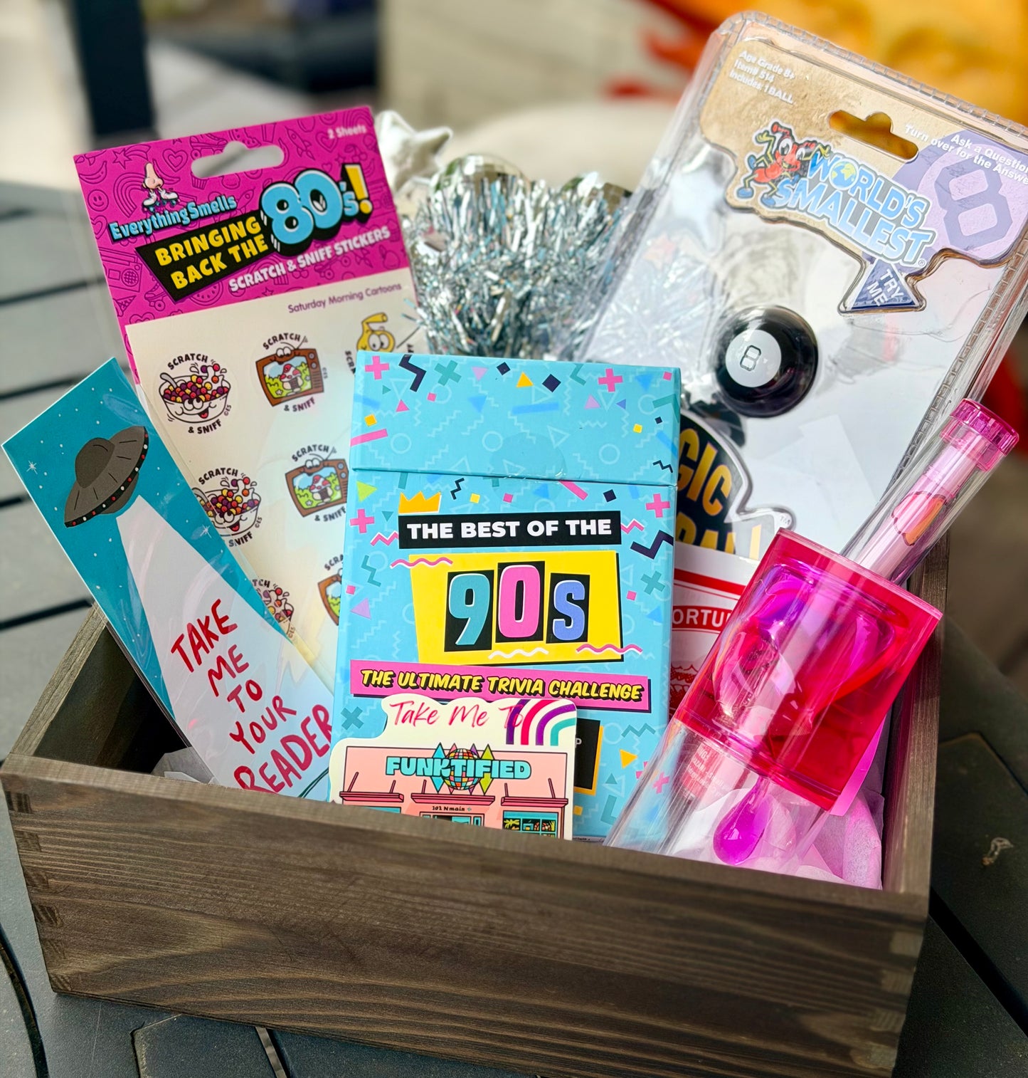 Collection of 1990s-themed items in a wooden box