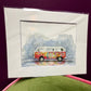 Framed artwork of a colorful van on a purple background
