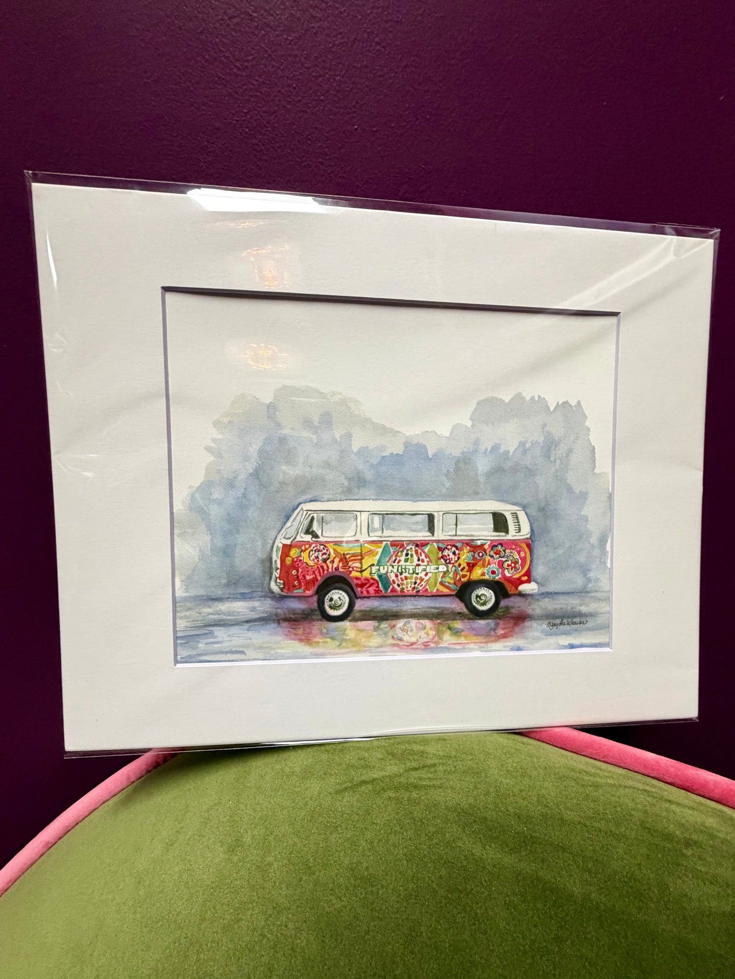 Framed artwork of a colorful van on a purple background