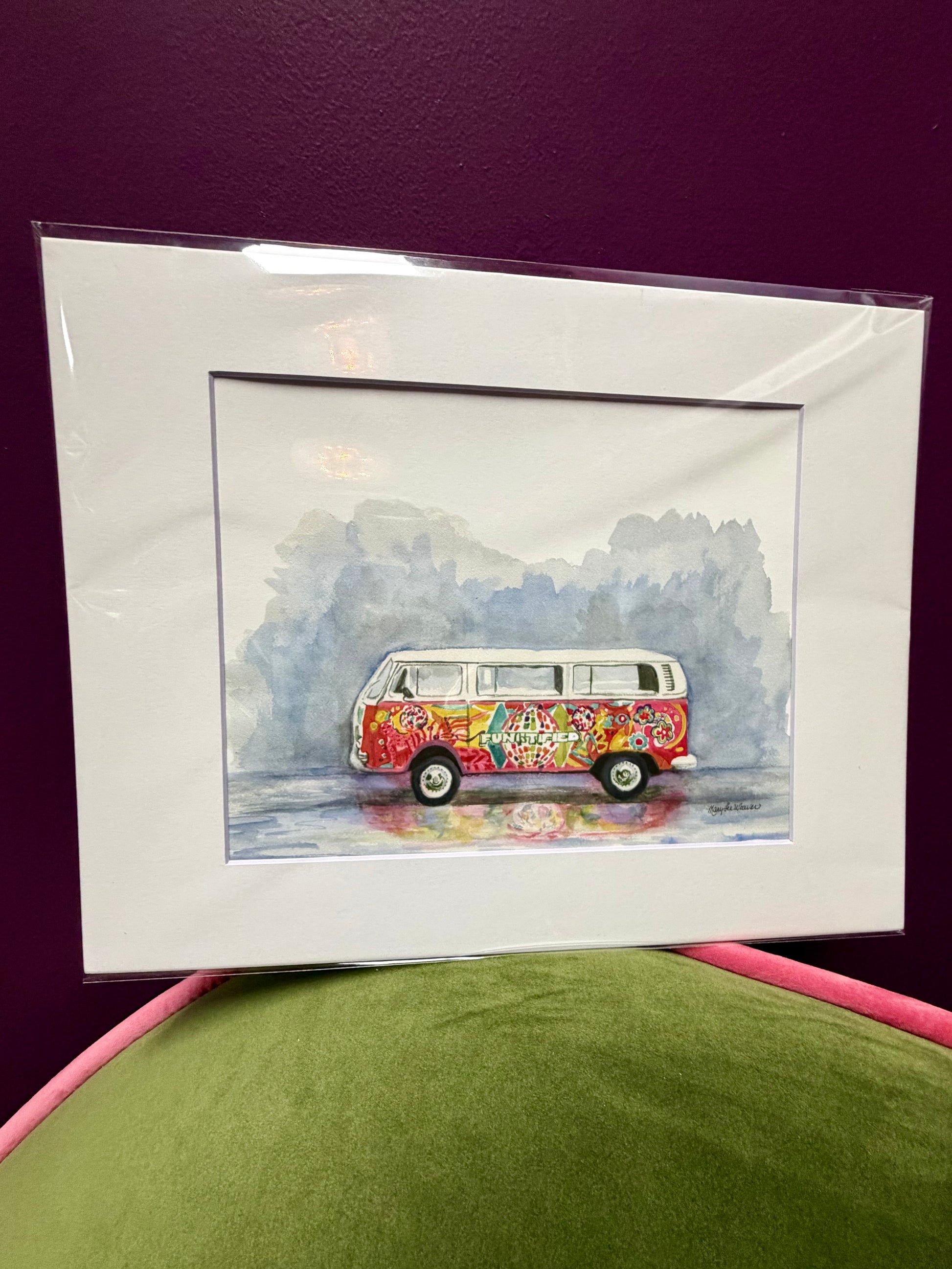 Framed artwork of a colorful van on a purple background