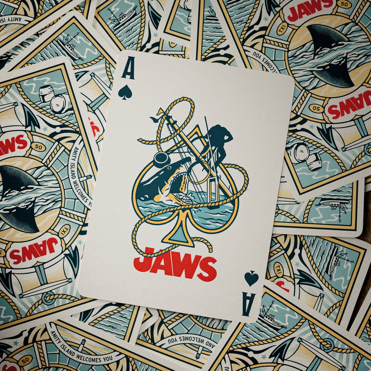 Playing card with 'Jaws' design on a background of more playing cards.