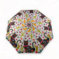 Colorful umbrella with cat and cactus pattern on a white background