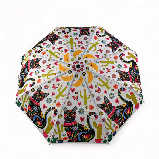 Colorful umbrella with cat and cactus pattern on a white background